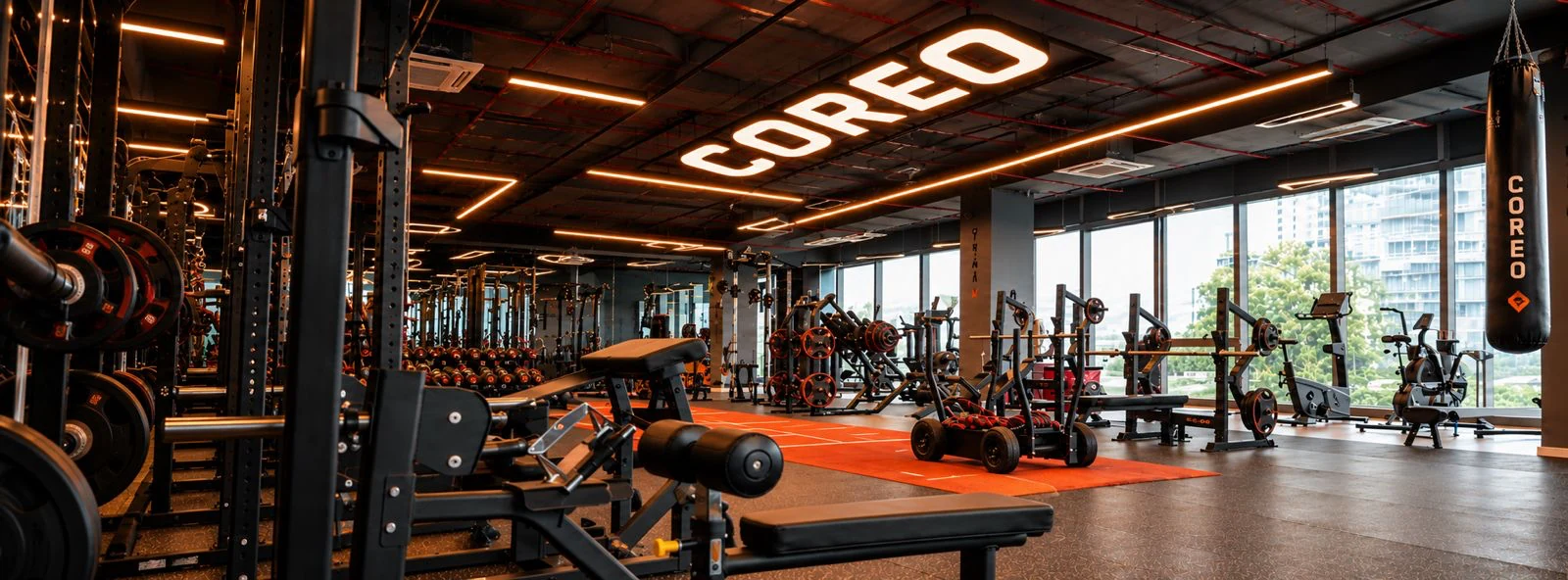 COREO gym floor with strength equipment and orange training track
