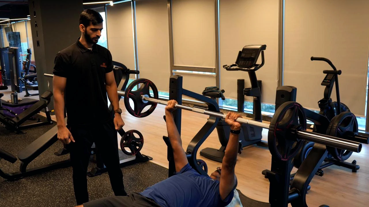 COREO member training with a coach on the strength floor