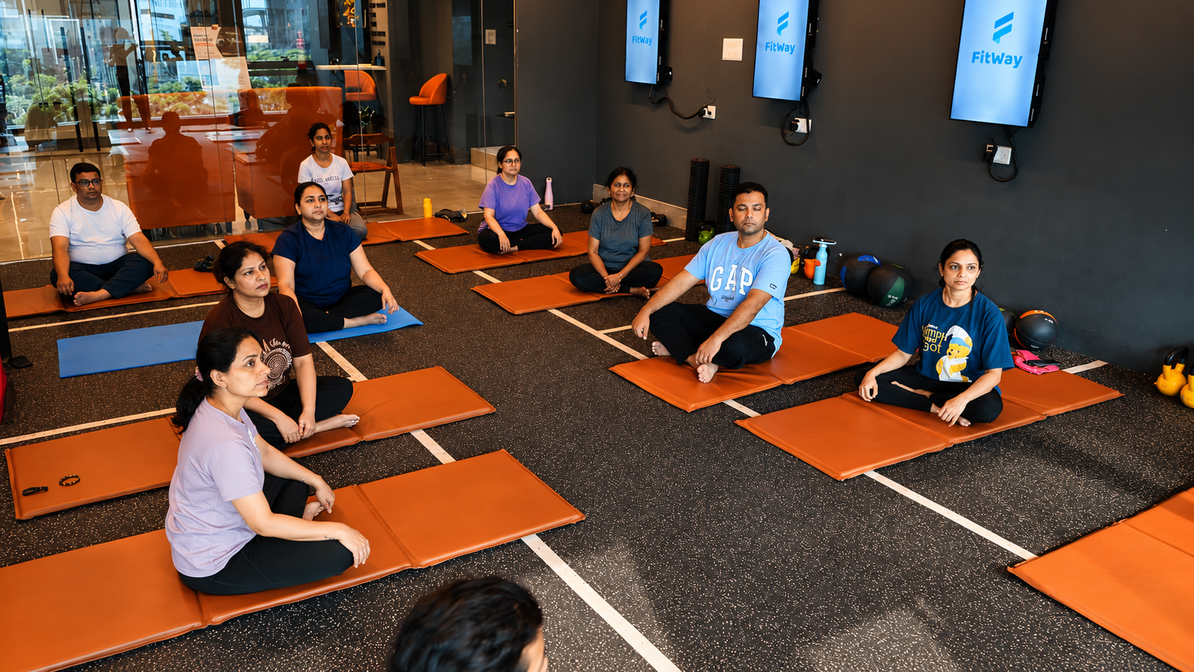 COREO members seated together on yoga mats