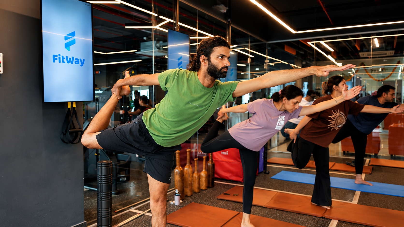 A member demonstrating a balance pose during yoga